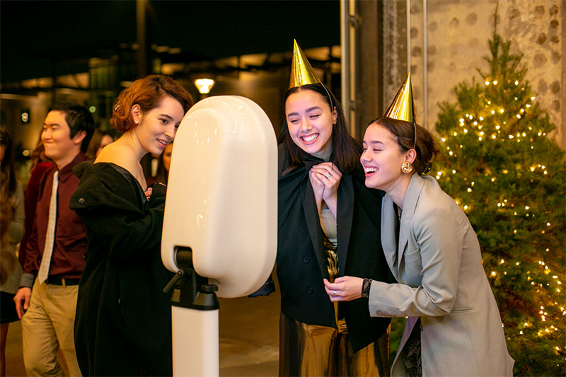 Guests laughing at an OMG! photo booth